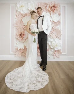 Las Vegas Wedding Couple Posing by Flower Wall